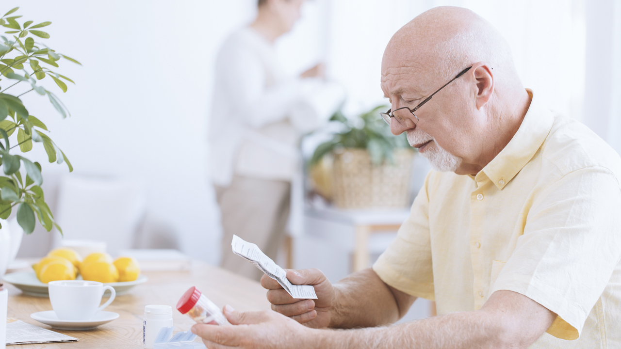 man-reading-medicines-leaflet